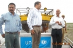 Mr Chaman Lal interacting with MR G D Tripathi, the   Deputy Commissioner of  Dibrugarh and C-NES\' Programe Manager Ashok Rao on board Akha  at Dibrugarh\'s Maijan Ghat .