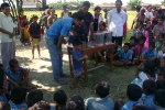 An enthusiatic child washing his hands with soap  as part of the global hand washing day at Tinsukia\'s Laika Pomua L P School, helped by Sanjay Sarma, Associate Programme Manager(in blue T shirt). Hiranya , DPO Boat Clinic  looks on.