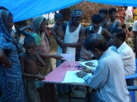 Health camp in progress on 29th October, 2008 at the Berabhanga Sapori in Dhubri. The attending doctors are Dr Ganesh Chandra Das (sitting extreme right) and Dr Abdul Warish