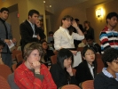 A long queue of students and participants wait to ask questions of the panel